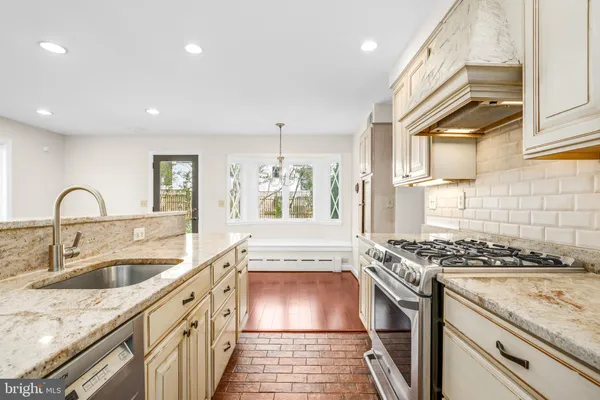 a kitchen that has a sink and a stove