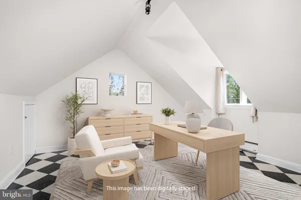 a living room with furniture a rug and white walls
