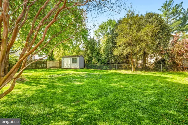 a backyard of a house with lots of green space and fountain