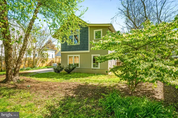 a front view of a house with a yard and shrubs