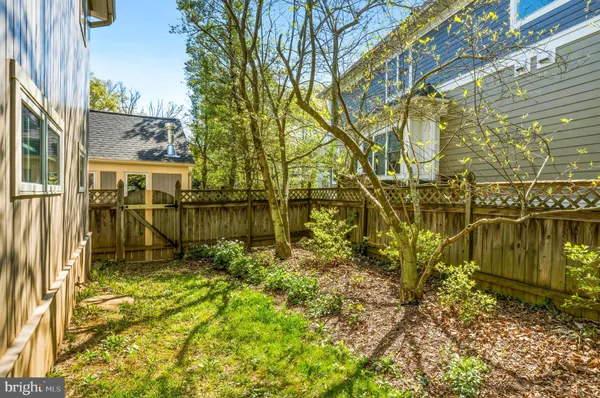 a view of a pathway of a house with a yard