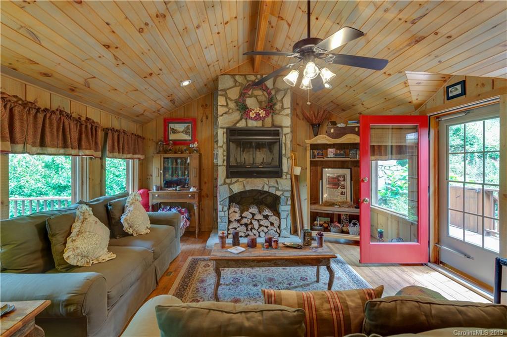 48 Tater Hill Farm Road Canton, NC 28716 - Photo 22 of 30 a living room with furniture a window and a chandelier