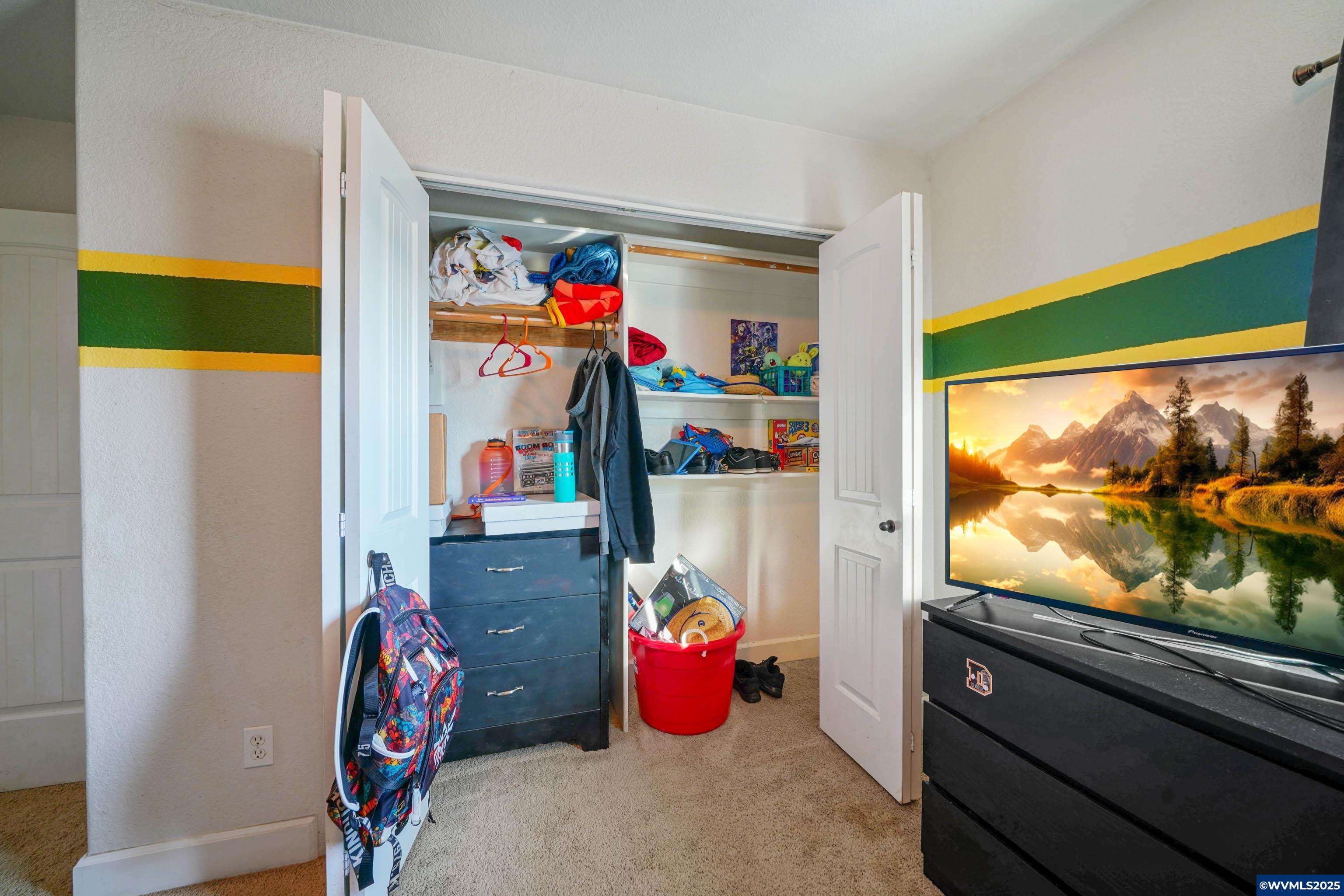 353 Northwest Reed Lane Dallas, OR 97338 - Photo 33 of 45 a bedroom with a bed and a flat screen tv