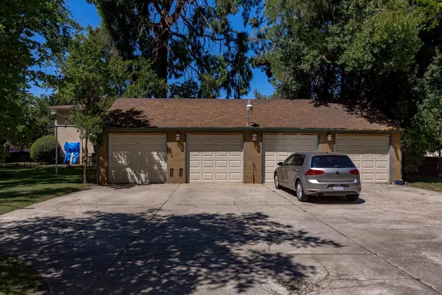 a view of a house with a yard and sitting area