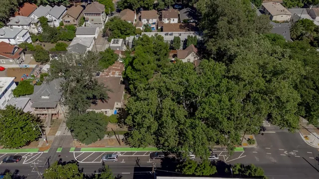 an aerial view of residential house with outdoor space and trees all around