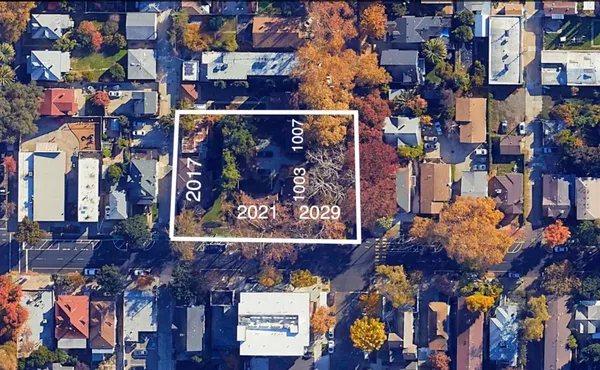 an aerial view of a house with outdoor space