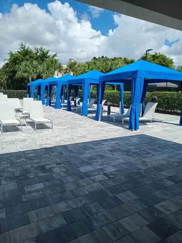a view of a house with backyard and sitting area