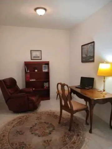 a living room with furniture and a lamp