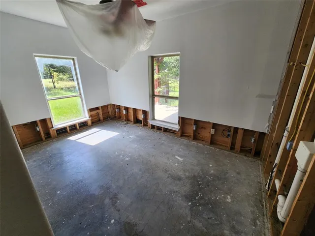 a view of an empty room and a window