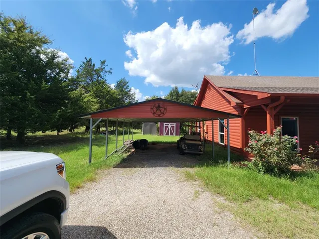 a yellow house with trees in front of it