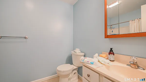 a bathroom with a sink toilet and a mirror