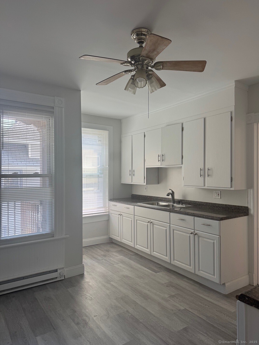 39 Maple Street New Haven, CT 06511 - Photo 1 of 10 a open kitchen with stainless steel appliances granite countertop a stove a sink and white cabinets with wooden floor next to windows