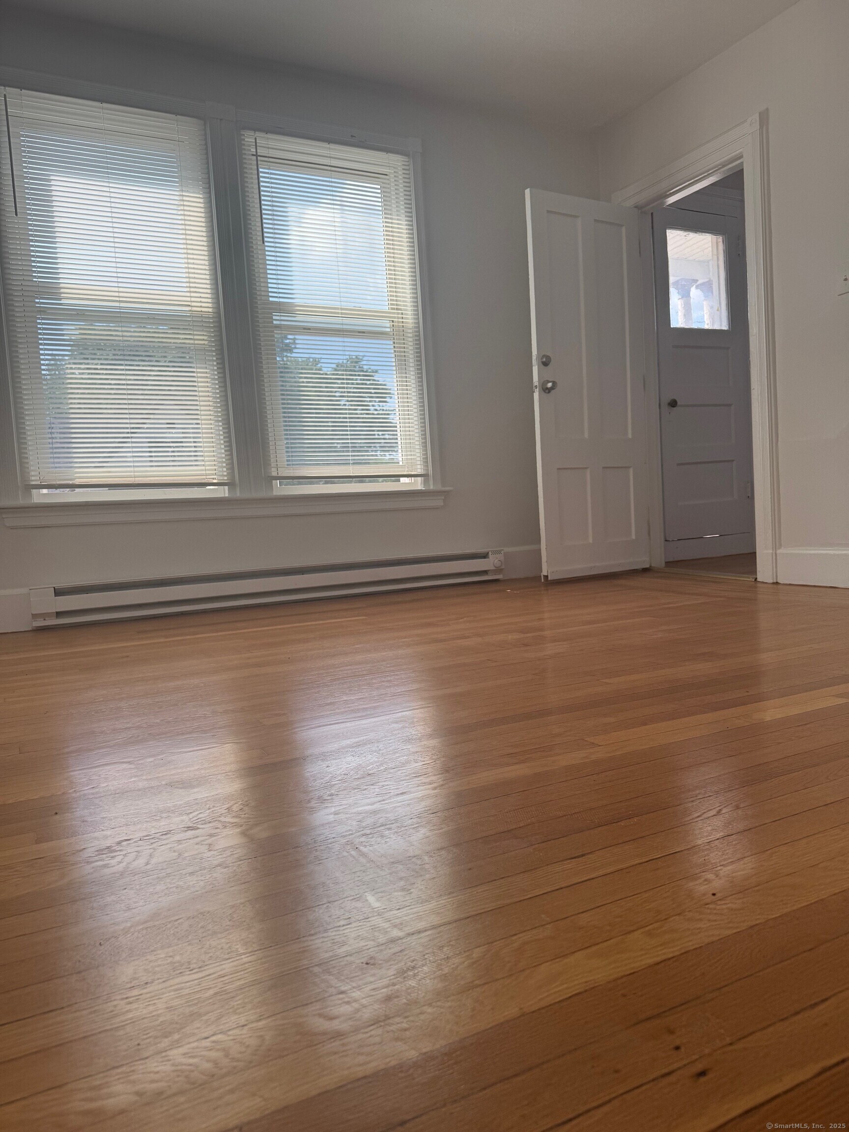 39 Maple Street New Haven, CT 06511 - Photo 4 of 10 an empty room with wooden floor and windows