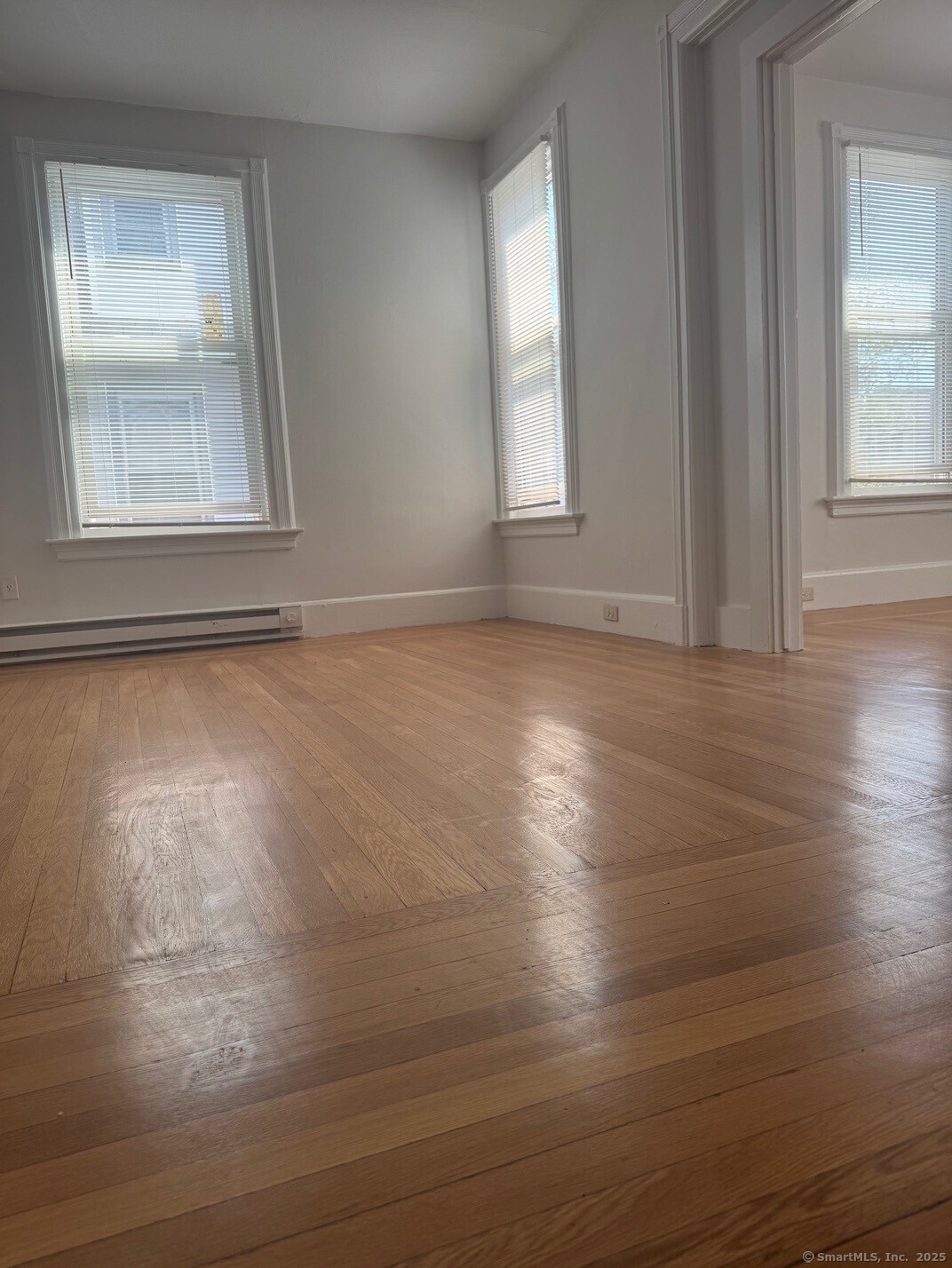 39 Maple Street New Haven, CT 06511 - Photo 5 of 10 an empty room with wooden floor and windows