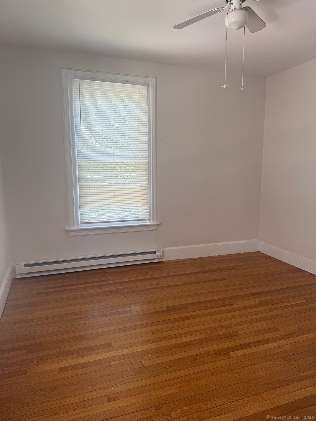 39 Maple Street New Haven, CT 06511 - Photo 7 of 10 a view of an empty room with wooden floor and a window