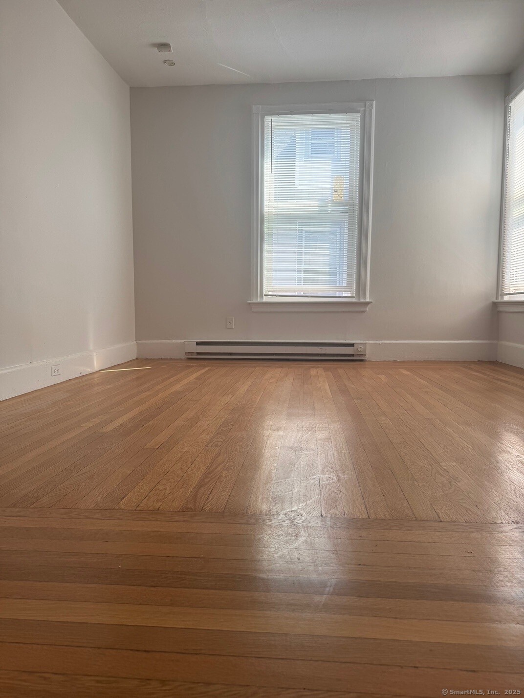 39 Maple Street New Haven, CT 06511 - Photo 9 of 10 a view of an empty room with wooden floor and a window