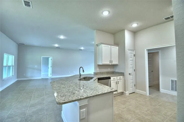 a bathroom with a granite countertop sink a toilet and shower