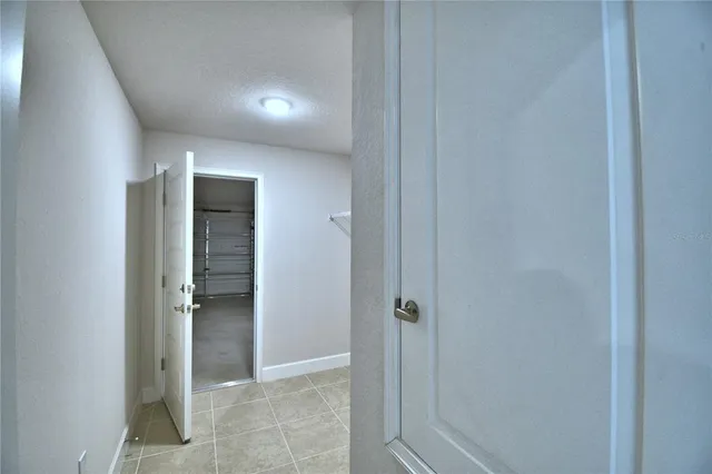 an empty room with closet and windows