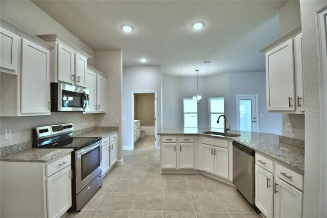 a bathroom with a granite countertop tub shower and sink