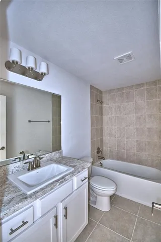 a bathroom with a toilet a sink and bathtub