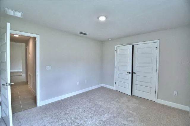 an empty room with closet area