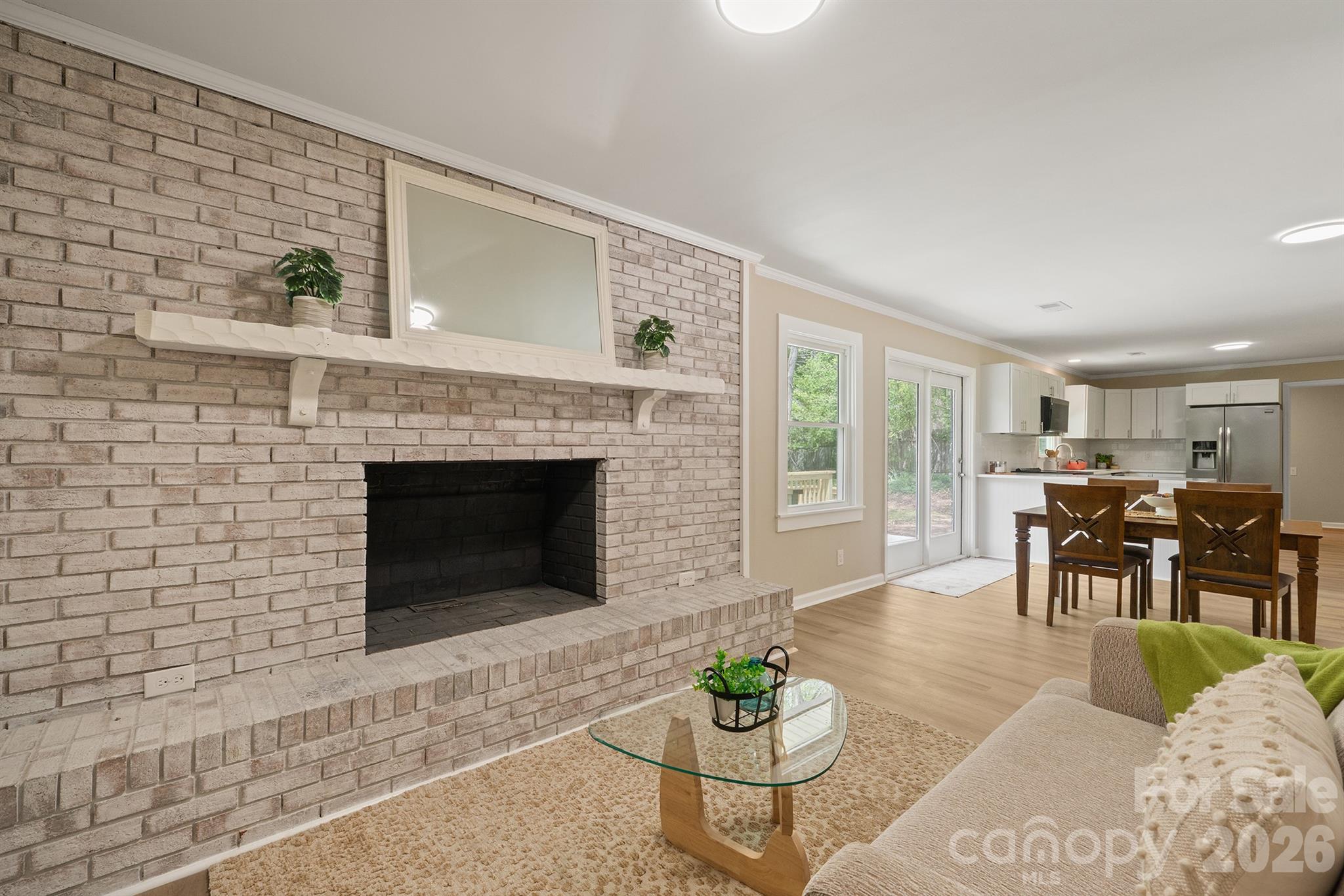 624 Flicker Street Concord, NC 28027 - Photo 13 of 47 a living room with furniture potted plant and a fireplace