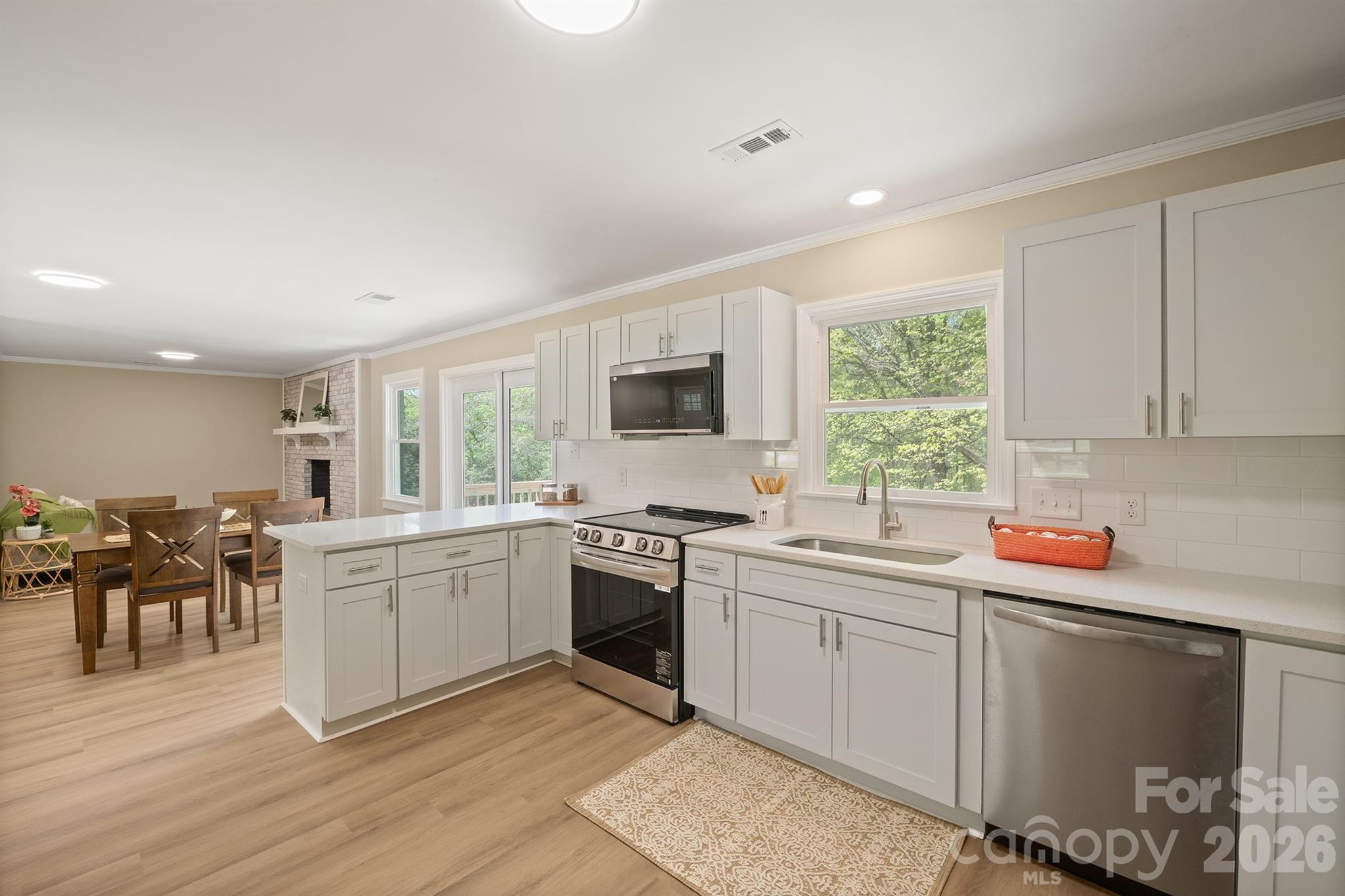 624 Flicker Street Concord, NC 28027 - Photo 16 of 47 a kitchen with a sink stove and cabinets