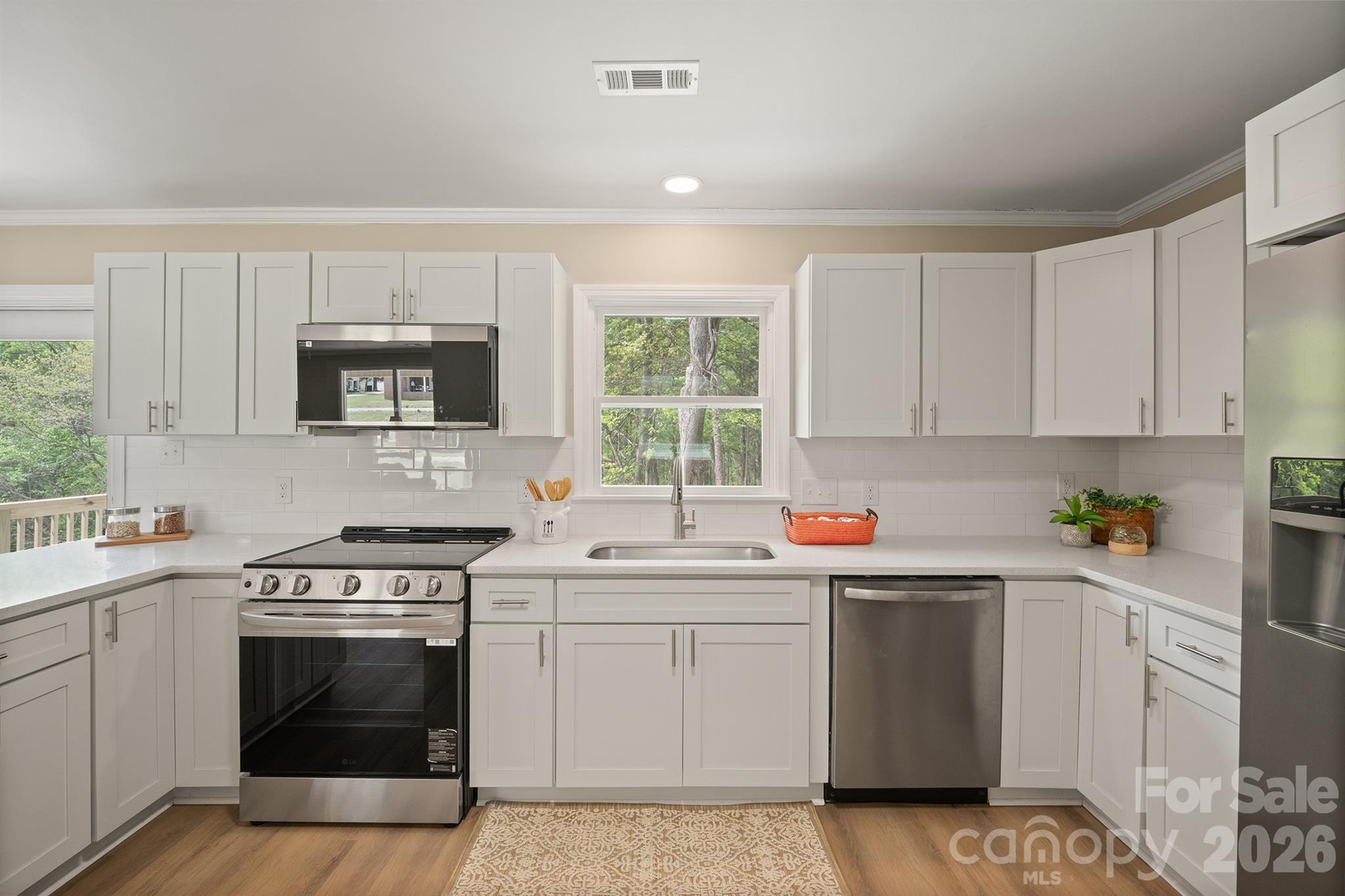 624 Flicker Street Concord, NC 28027 - Photo 18 of 47 a kitchen with a sink stove and microwave
