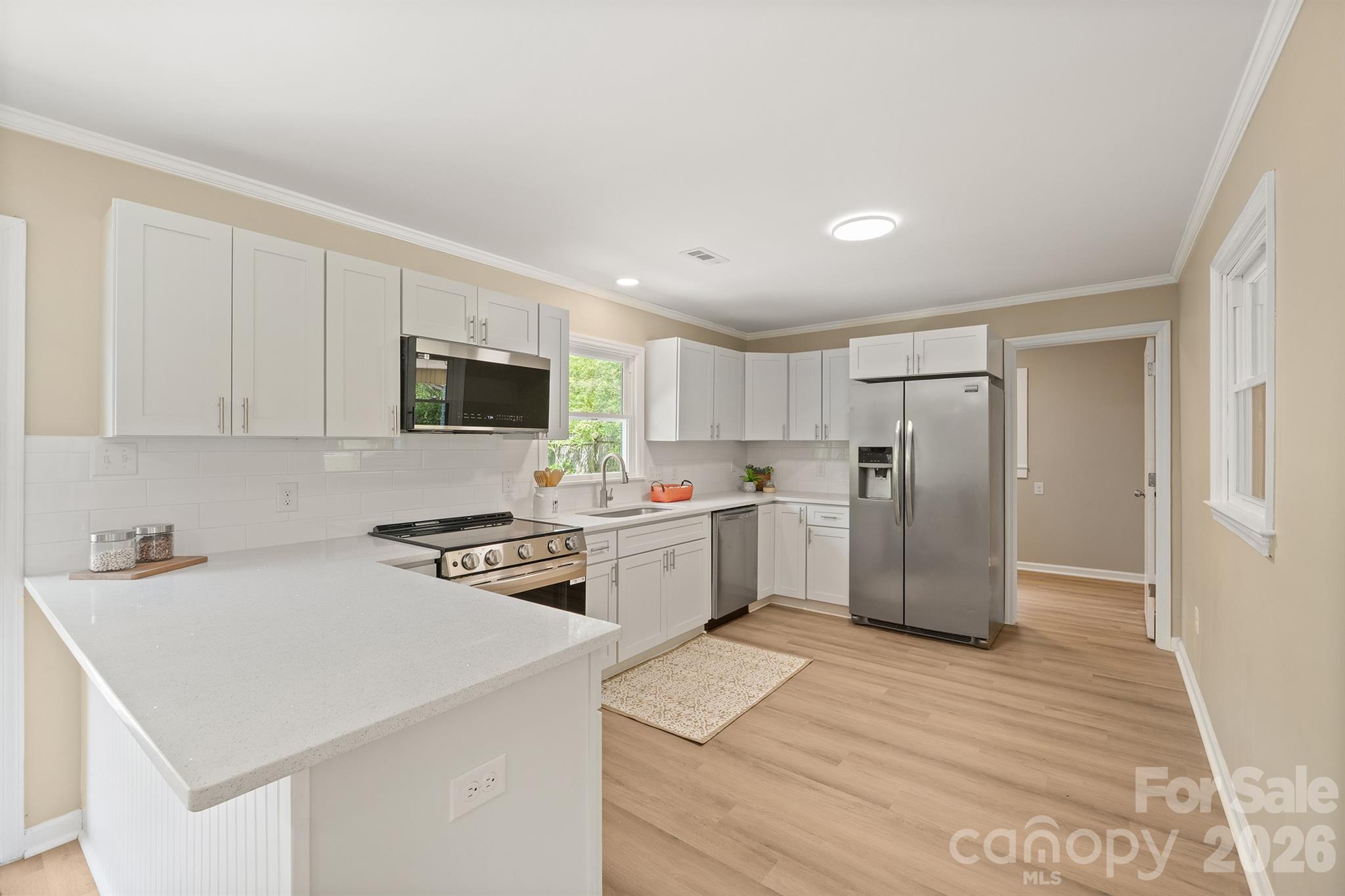 624 Flicker Street Concord, NC 28027 - Photo 19 of 47 a kitchen with a white stove top oven and refrigerator