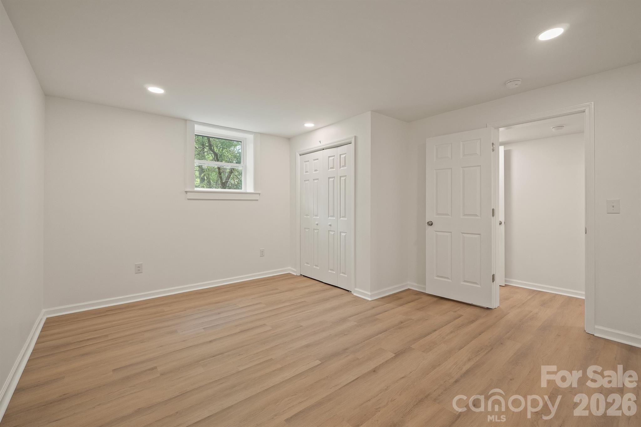 624 Flicker Street Concord, NC 28027 - Photo 24 of 47 a view of an empty room with wooden floor and closet