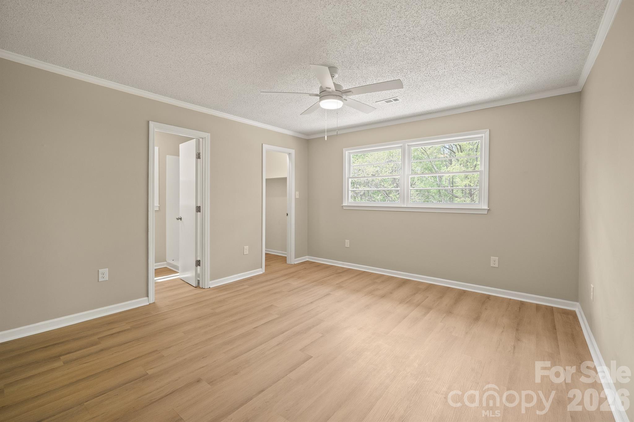 624 Flicker Street Concord, NC 28027 - Photo 26 of 47 a view of an empty room with wooden floor and a window
