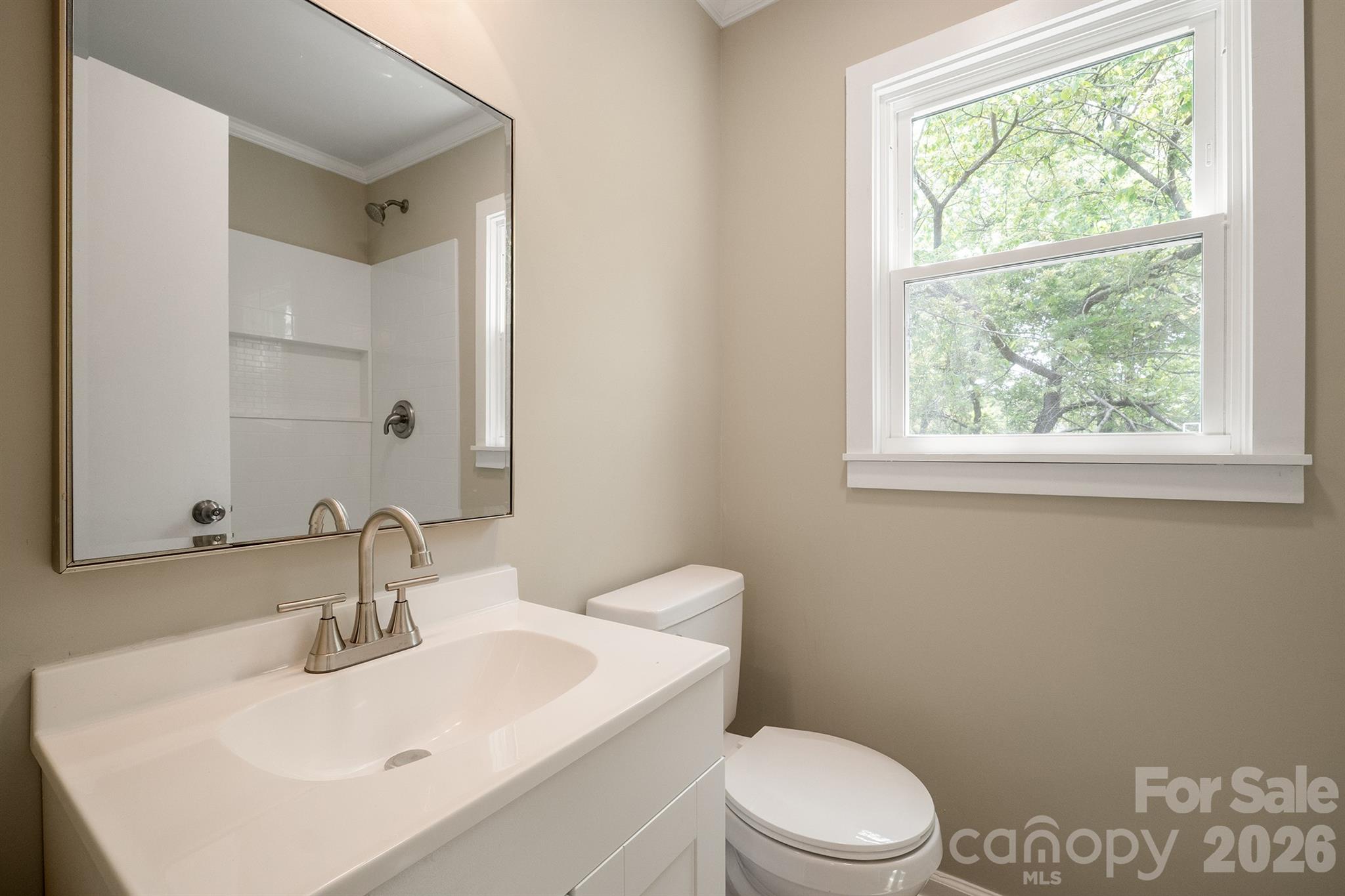 624 Flicker Street Concord, NC 28027 - Photo 29 of 47 a bathroom with a sink a toilet and a mirror