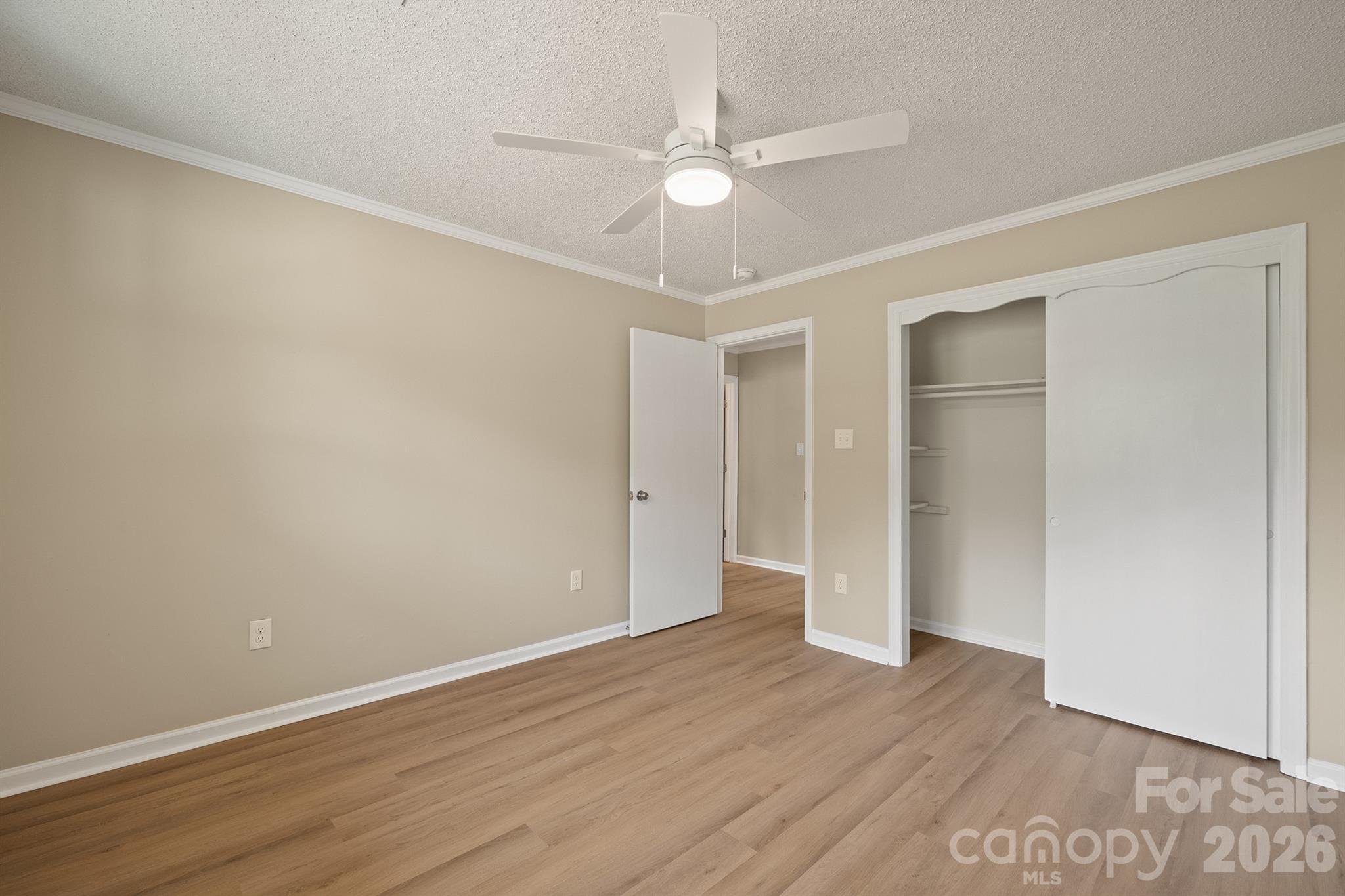 624 Flicker Street Concord, NC 28027 - Photo 30 of 47 an empty room with wooden floor and fan