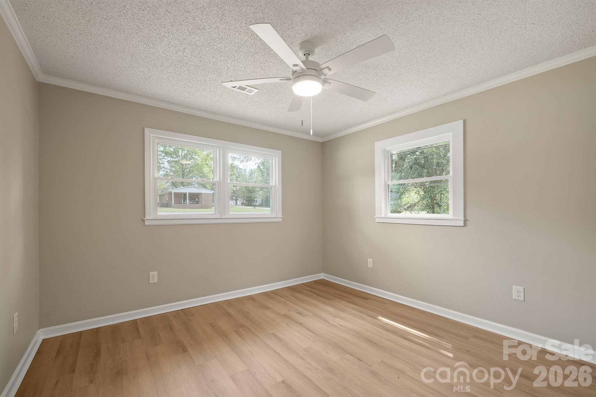 624 Flicker Street Concord, NC 28027 - Photo 31 of 47 a view of an empty room with wooden floor and a window
