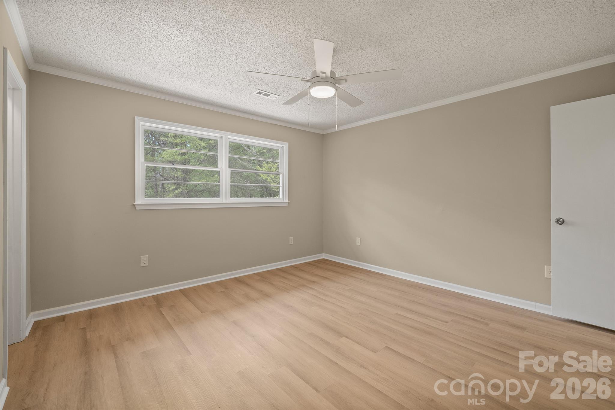 624 Flicker Street Concord, NC 28027 - Photo 32 of 47 an empty room with wooden floor and windows