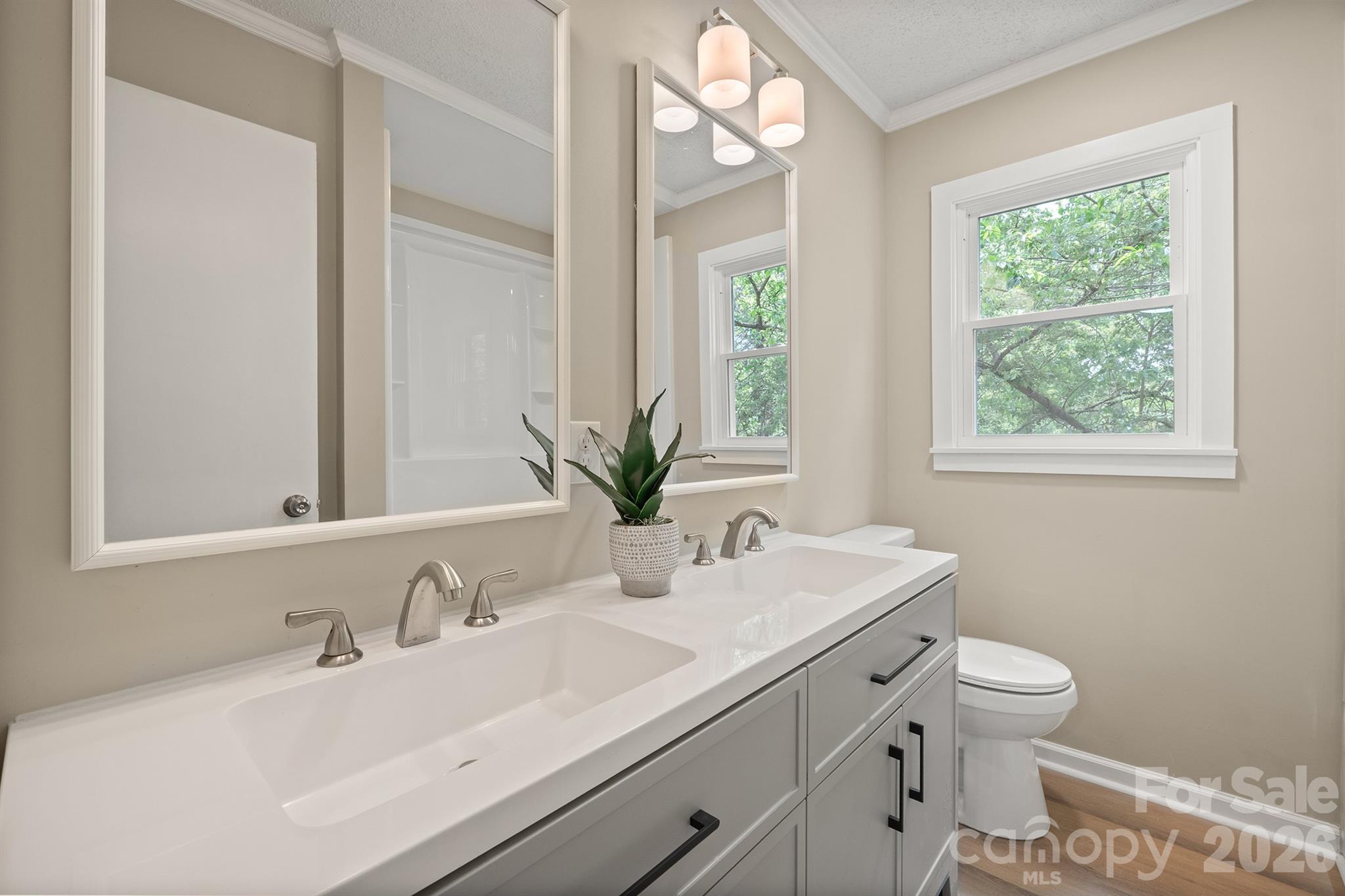 624 Flicker Street Concord, NC 28027 - Photo 34 of 47 a bathroom with a granite countertop sink a toilet and a mirror