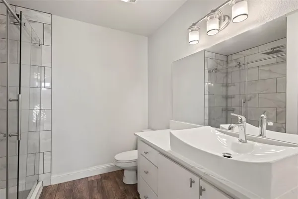 a bathroom with a sink toilet and shower