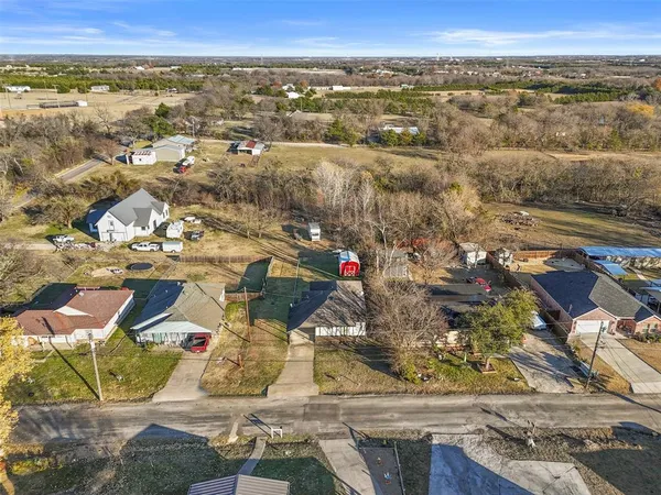 an aerial view of residential houses with outdoor space
