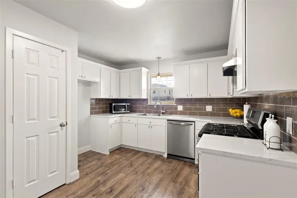a kitchen with a white cabinets and white appliances