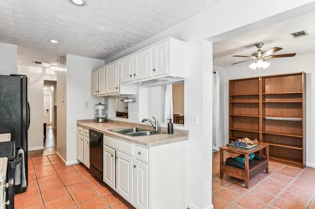 a kitchen with a stove window and a refrigerator