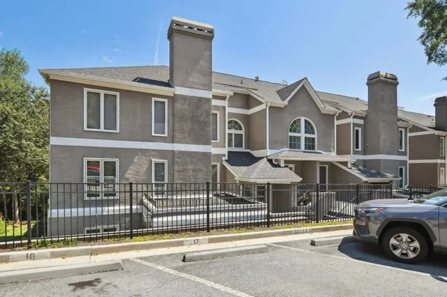 a front view of a house with a parking space