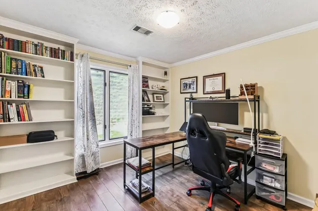 a view of a workspace with furniture and a bedroom