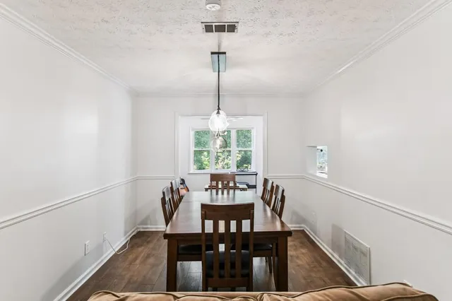 a view of a dining room with furniture window and wooden floor