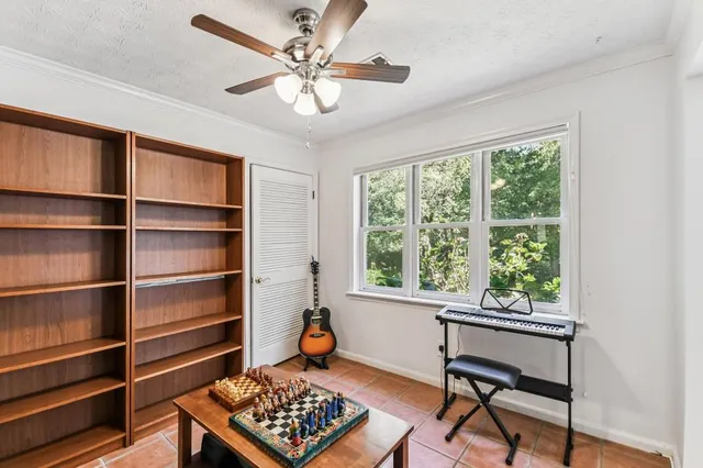 a view of a workspace with furniture and a window