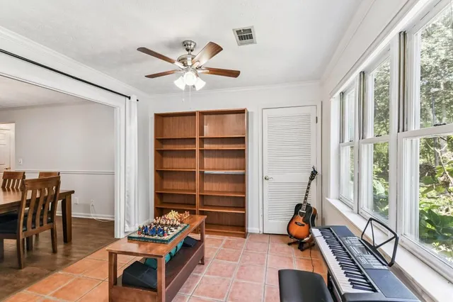 a living room with furniture gym equipment and a large window