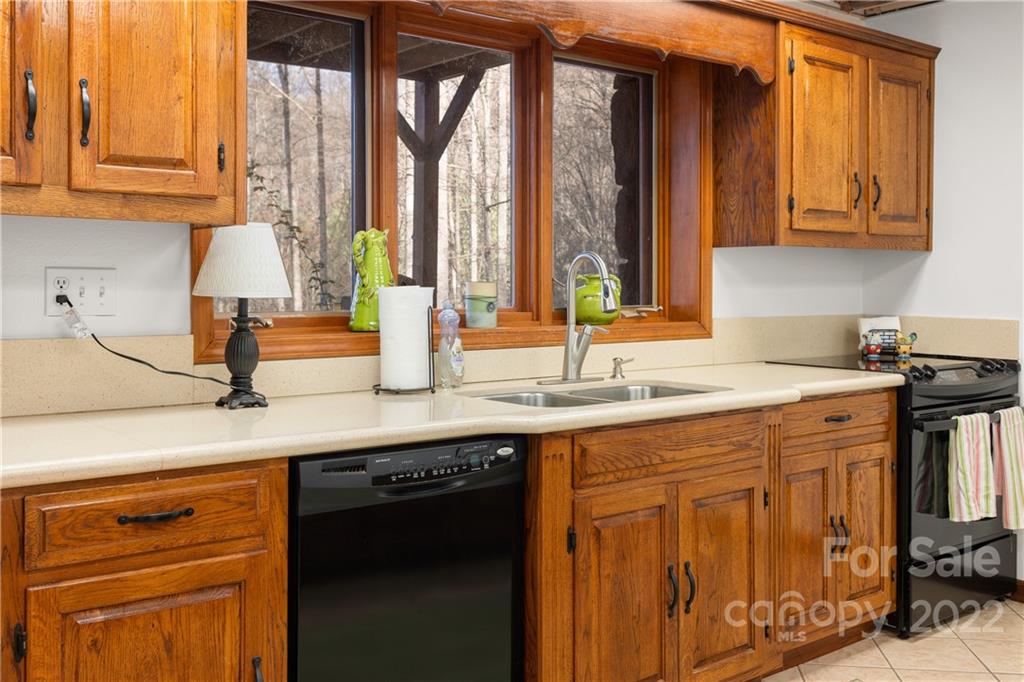 80 Lick Log Road Sylva, NC 28779 - Photo 17 of 25 a kitchen with stainless steel appliances granite countertop a sink a stove and cabinets