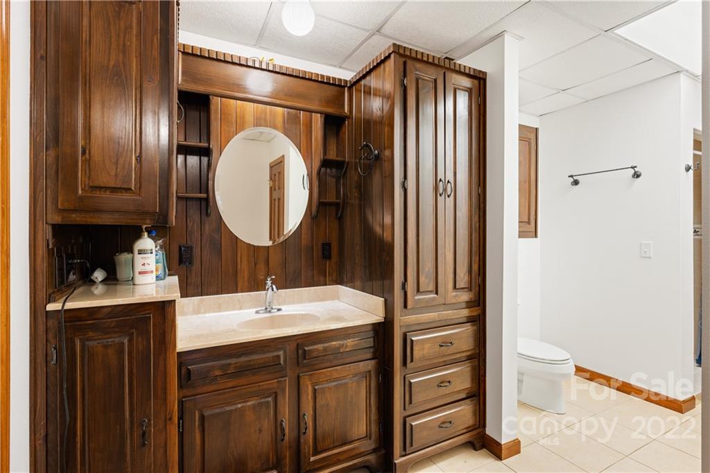80 Lick Log Road Sylva, NC 28779 - Photo 18 of 25 a bathroom with a sink a toilet and shower curtain