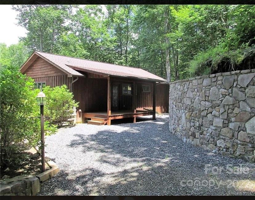 80 Lick Log Road Sylva, NC 28779 - Photo 24 of 25 a view of a barn with a large window and large trees