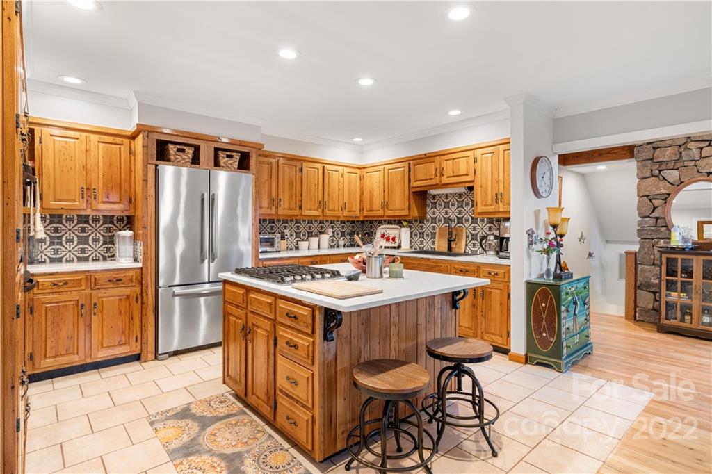 80 Lick Log Road Sylva, NC 28779 - Photo 4 of 25 a kitchen that has a kitchen island wooden cabinets and stainless steel appliances