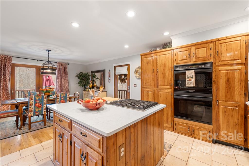 80 Lick Log Road Sylva, NC 28779 - Photo 5 of 25 a dining hall with stainless steel appliances kitchen island granite countertop a table chairs and a refrigerator